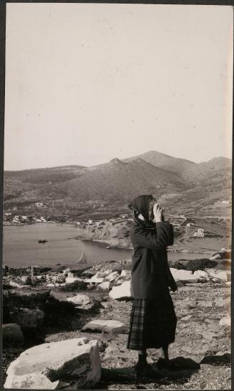 Sunium. Temple of Poseidon. Woman taking a picture of the temple.