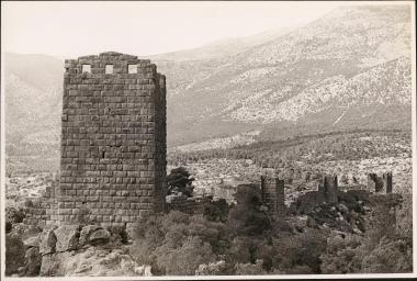 Orchomenos. Tower and fortified wall with mountains in the distance