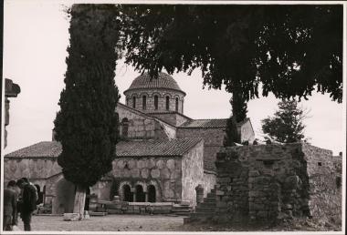 Byzantine church with big cypress tree in front