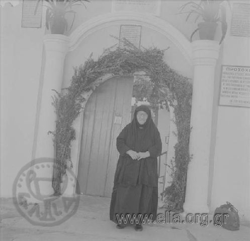 Nun at the gate of the Holy Trinity -St. Nektarios monastery.