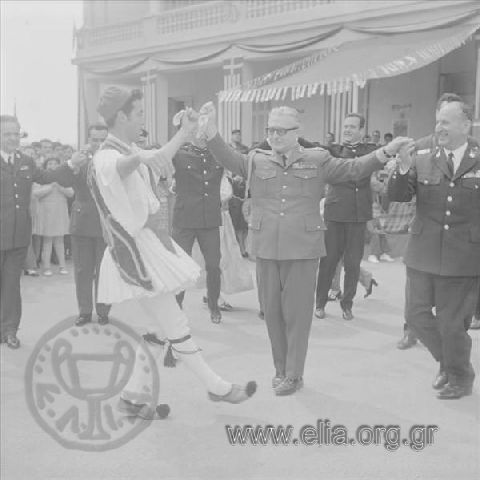 Easter celebration at a military camp. Regent Lieutenant-General Georgios Zoïtakis and Commander of the Greek  Military Police Dimitris Ioannidis cracking red Easter eggs