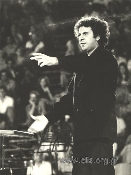 Mikis Theodorakis conducting an orchestra