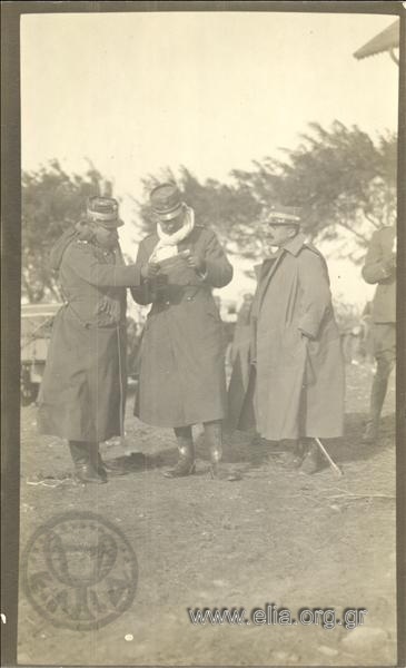 Crown Prince Konstantinos and a top-ranKing officer studying a document