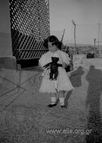 Little Eirini N. Makka holding a doll.