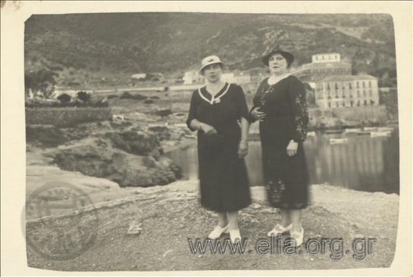 Portrait of two women at a seaside settlement.