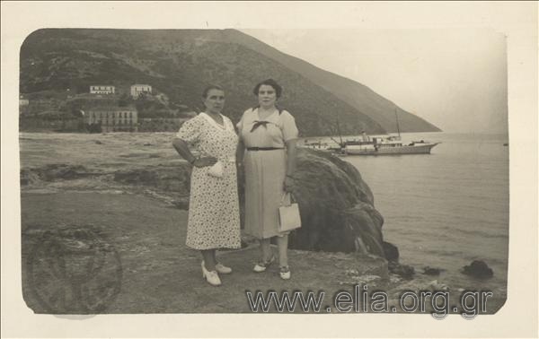 Portrait of two women at a seaside settlement.