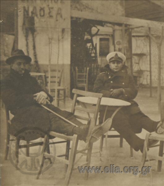 Two men on café chairs