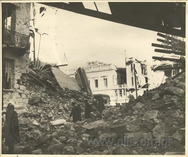 Athenians treading through houses reduced to rubble - December rioting.