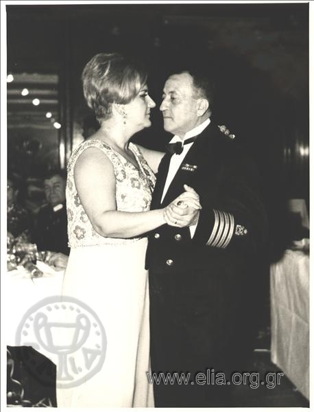 The wife of vicegerent Georgios Zoitakis dancing with a Navy officer in a formal celebration.