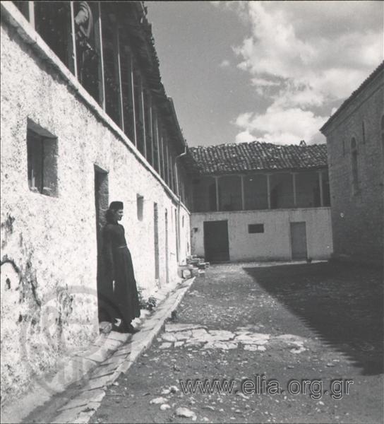 Agia Lavra Monastery, monk in a courtyard.