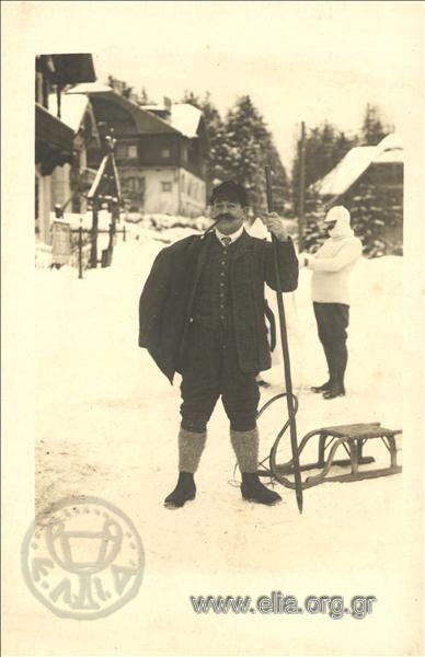 Portrait of a man with a sled in the snow