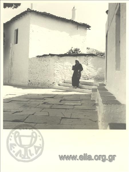 High in the town, a priest in an alley.