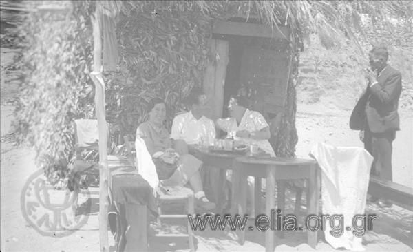 Excursion of the Travel Club to Mt. Athos, 28/6-2/7. The group of people outside a hut made of twigs on the beach