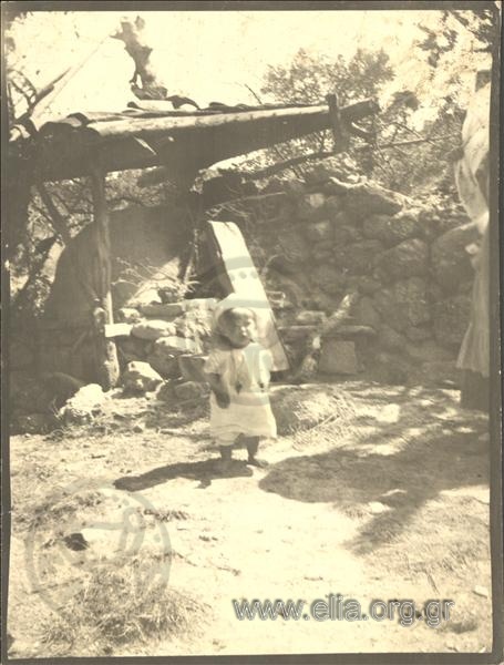 Barefoot child in a yard.