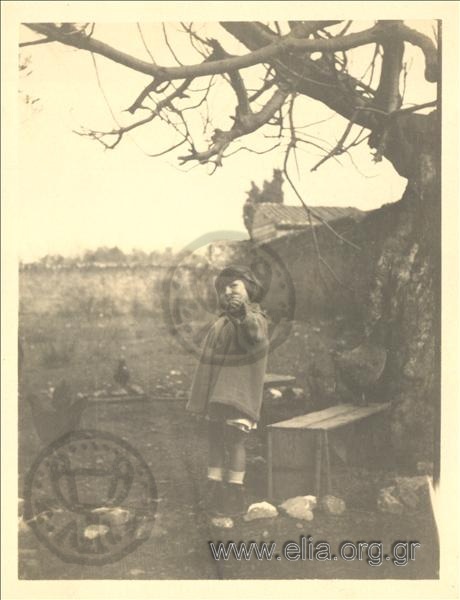 Alexandros and Alma Deligeorgis playing with animals in the yard