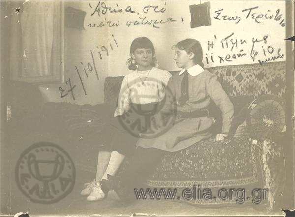 Two young girls in a sofa