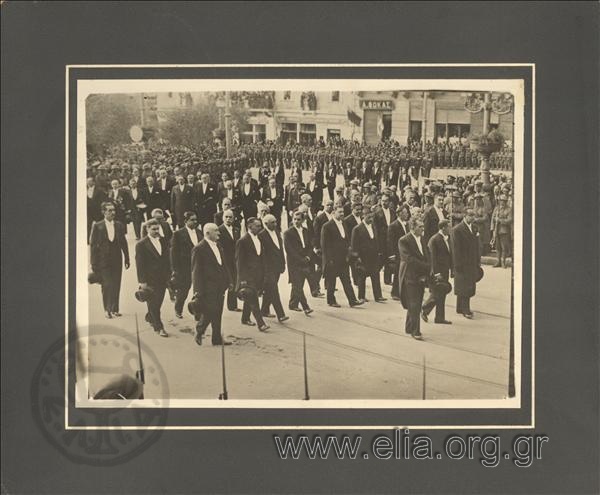 The funeral of a politician (?). Members of the city council of the Athens Municipality follow the cortege.