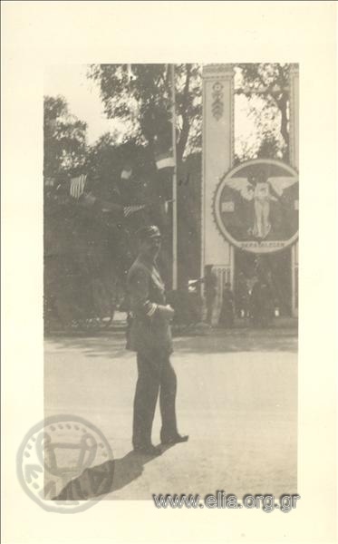 7th Olympic Games, Antwerp 1920. A Greek  sergeant poses in the open air, near the entrance of an exhibition or a playing field.