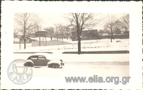 Snowy street and car in America.