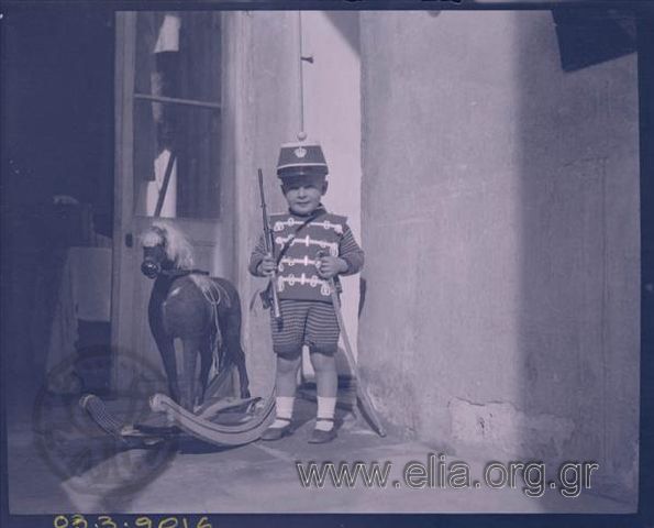 Boy disguised as a soldier with toys