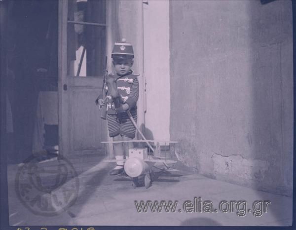 Boy disguised as a soldier with toys