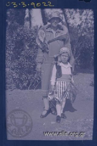 Boy disguised as woman in a garden