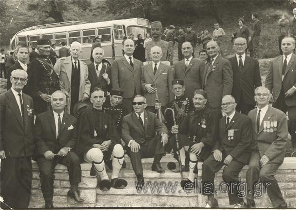 Group portrait in front of a monument to Paul  Melas, in a memorial of the fallen in the Macedonian Wars.