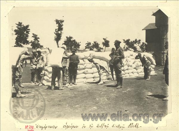 Asia Minor campaign, unloading flour under the supervision of a Greek officer at the Usak railroad station.