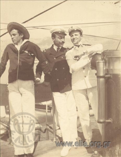Officers and a sailor on the deck of a ship