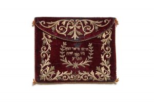 Envelope bag for prayer shawl, wine red velvet with gold embroidery in couching technique on the lap and borders, front side incribed with owner's name in a wreath, edged with braided string, belonged to Hayim Meir Hefetz, Ioannina.