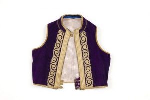 Boy's dark violet velvet jacket, trimmed and edged with gold cord.
