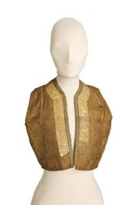 Ochre gold brocade waistcoat trimmed with gold braid.