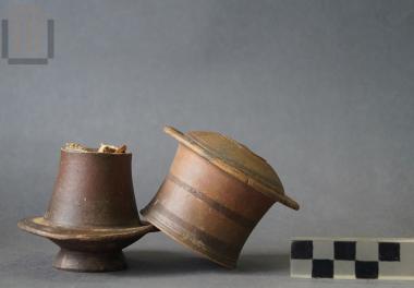 Black-glazed pyxis with a lid